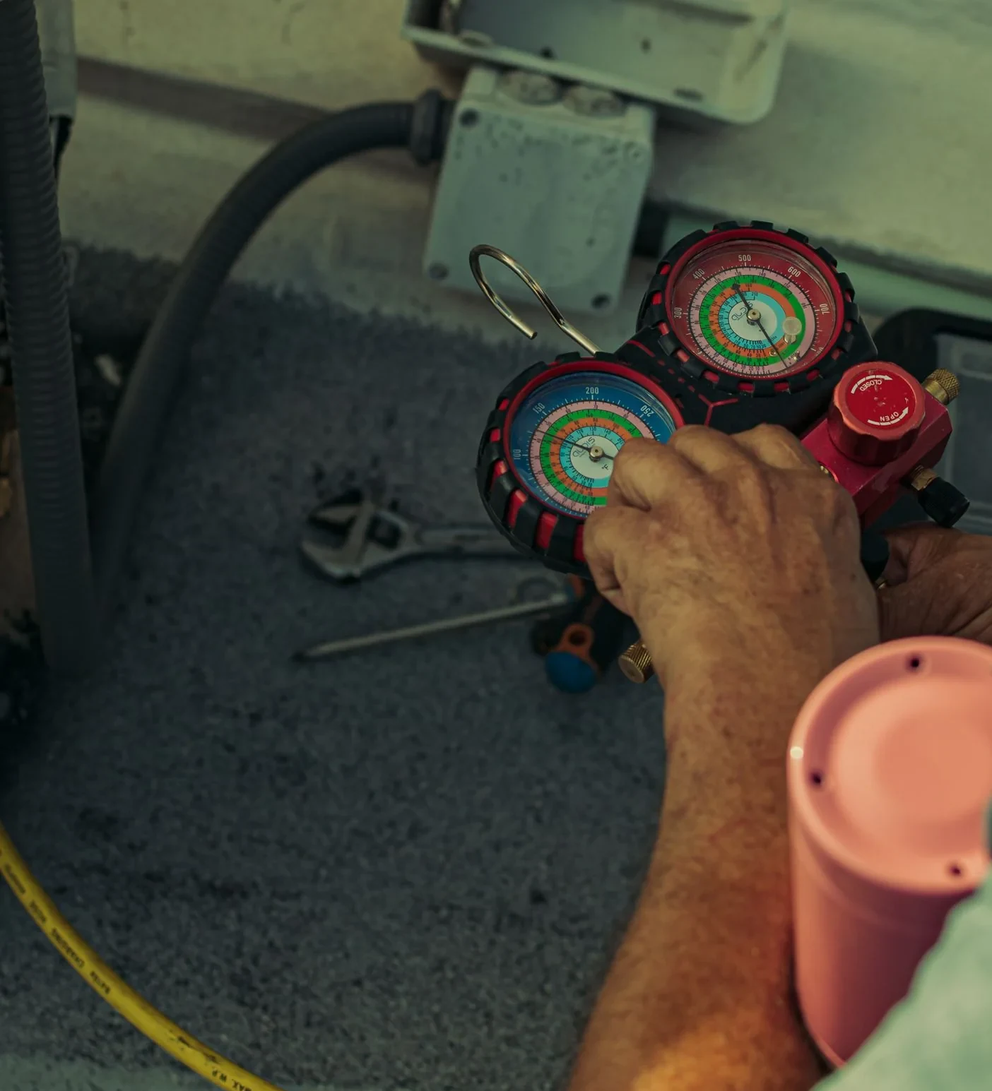 Refrigerant manifold gauges being used during air conditioning service