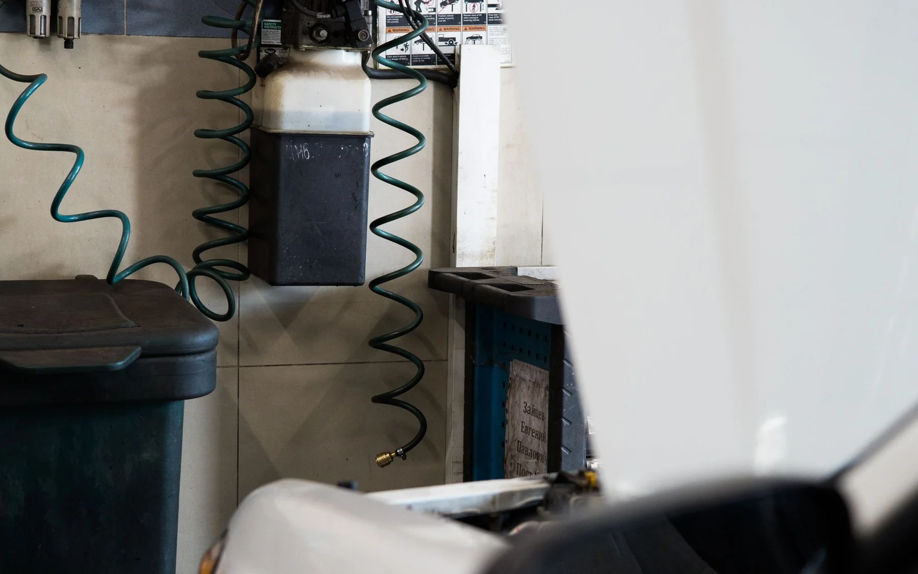 Vehicle positioned inside a clean automotive service workshop