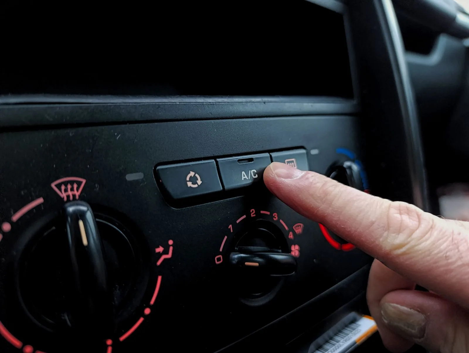 Close-up of a vehicle air conditioning control being adjusted