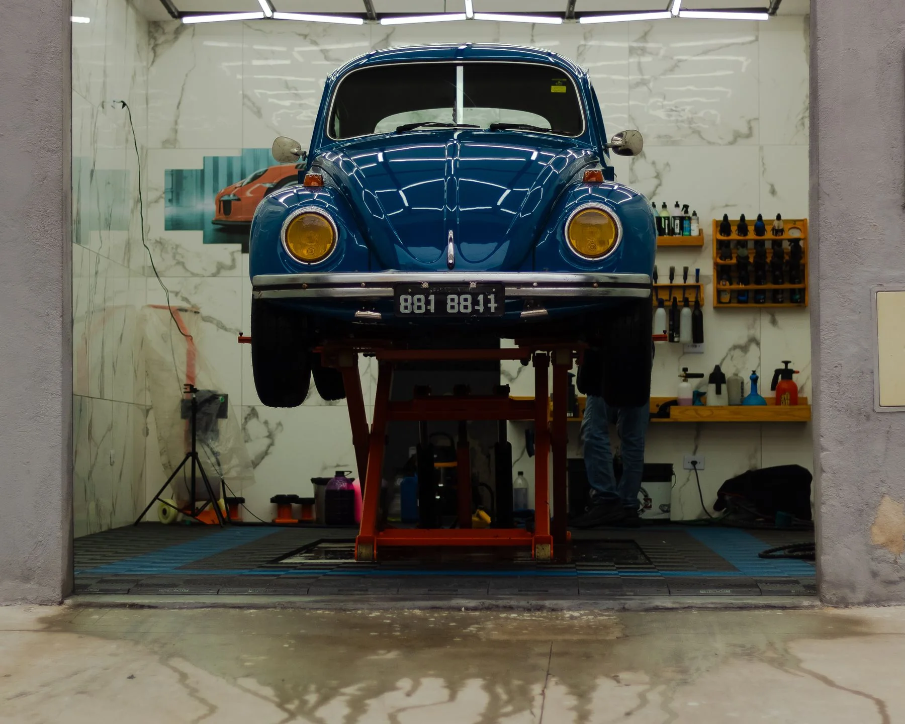 Classic vehicle positioned on a workshop lift